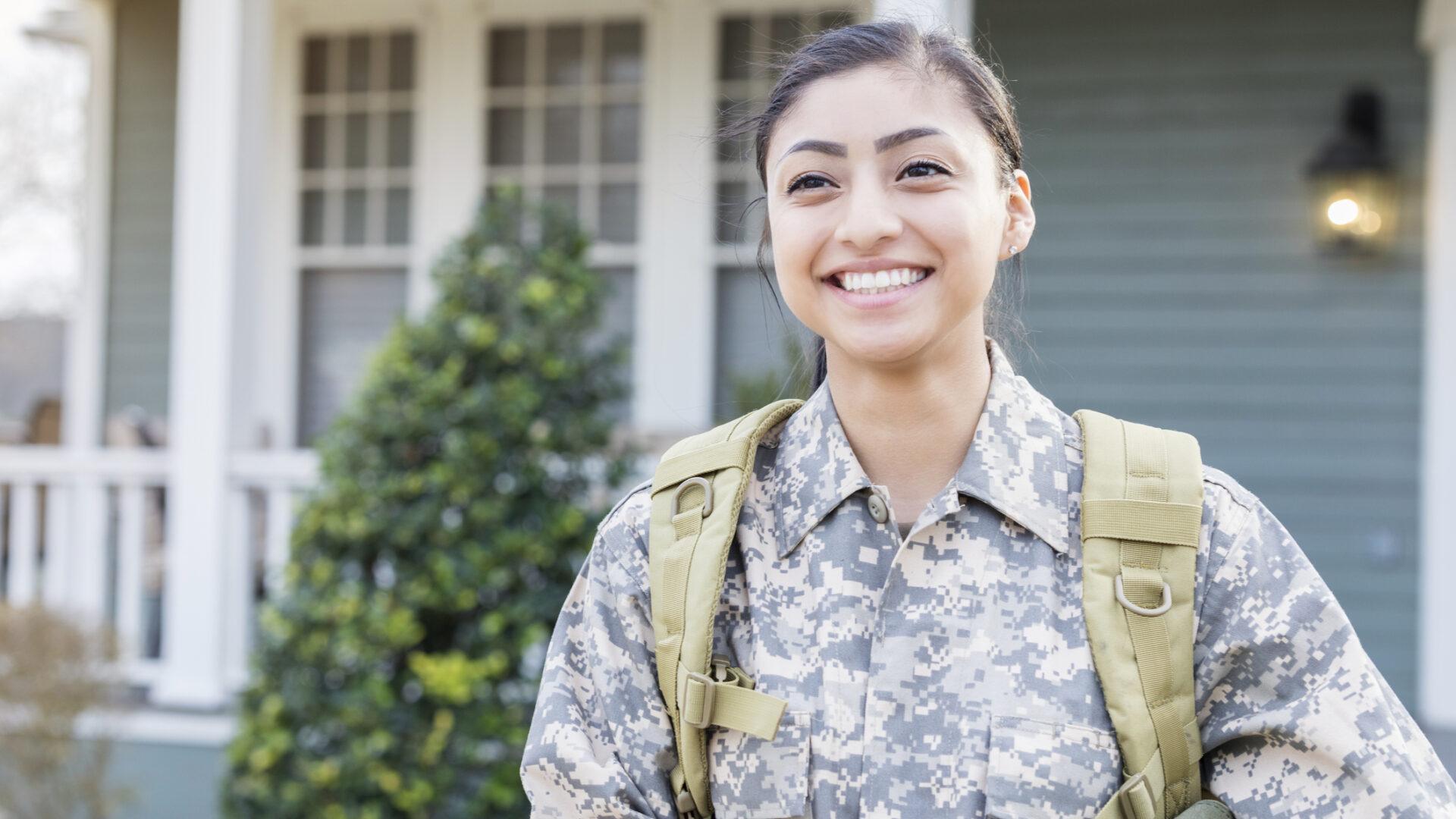 A smiling student in military fatigues.