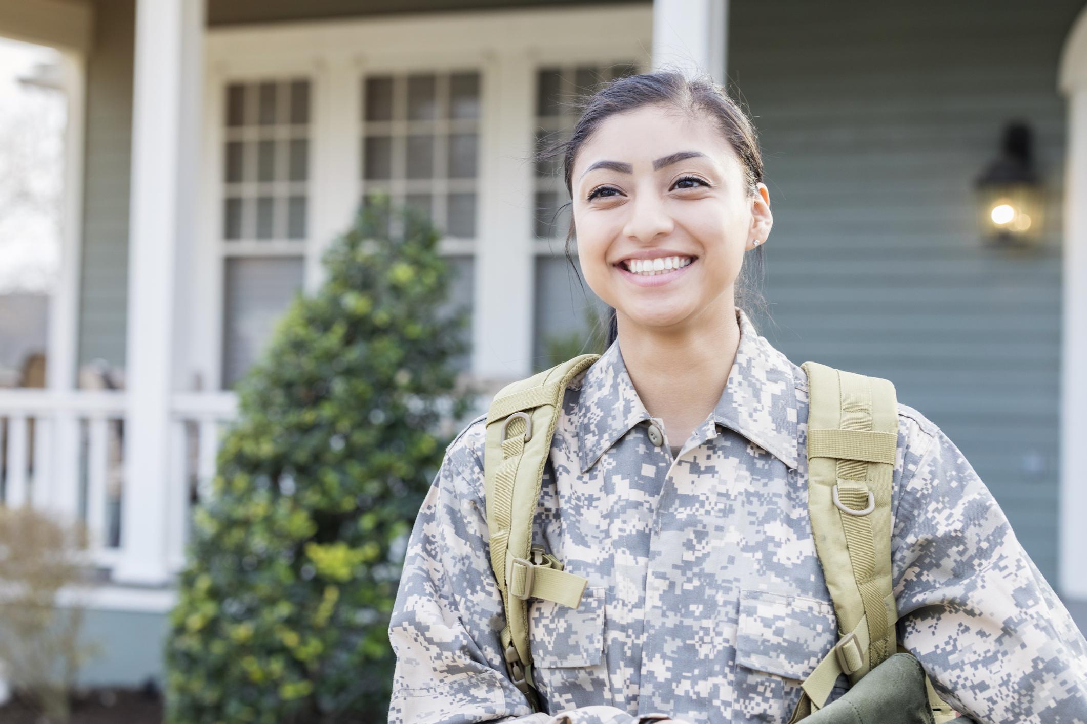 A smiling student in military fatigues.