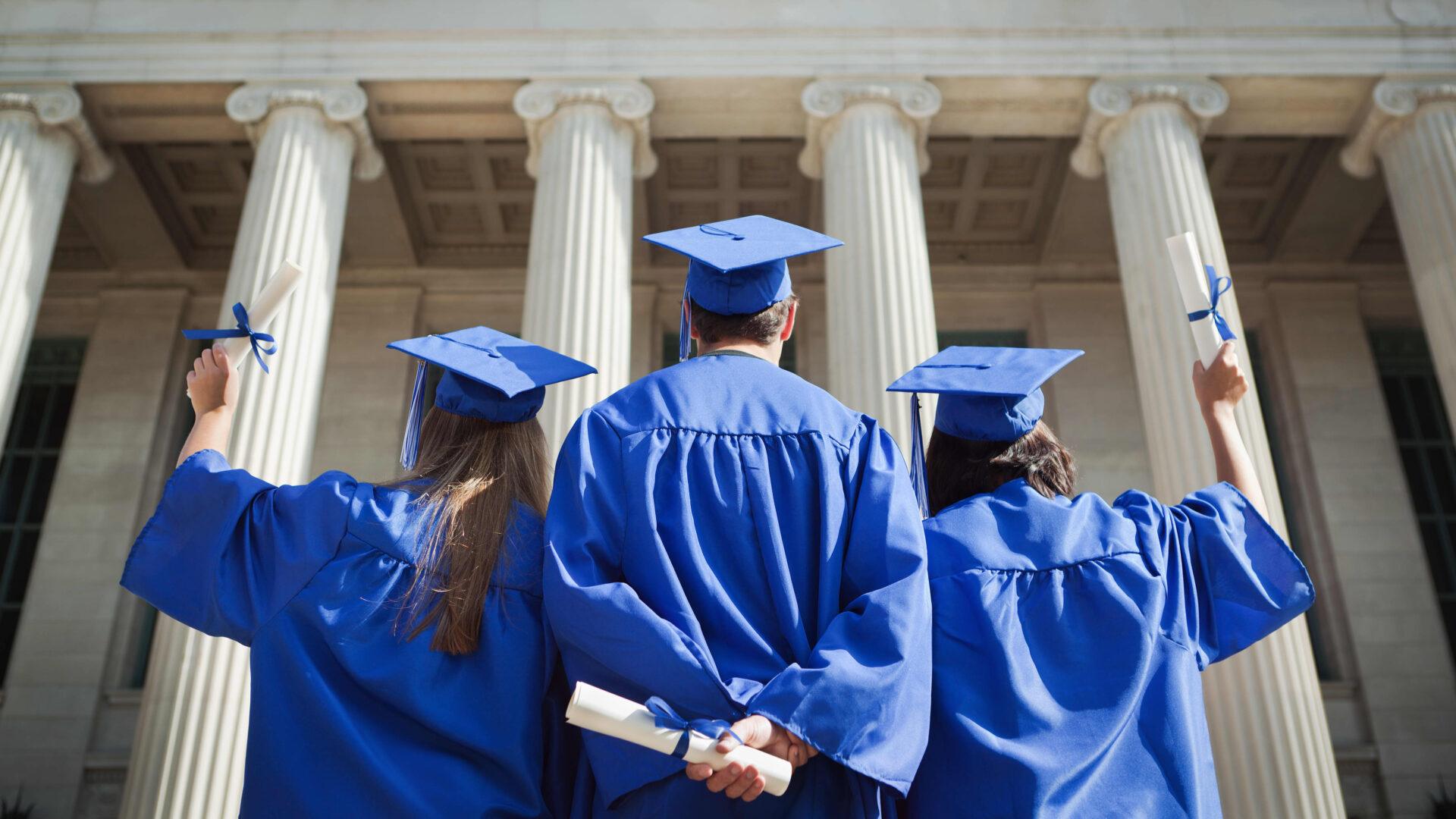 A group of students wearing blue gowns.