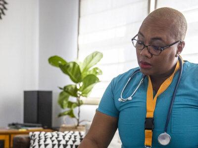 A woman in scrubs reading.