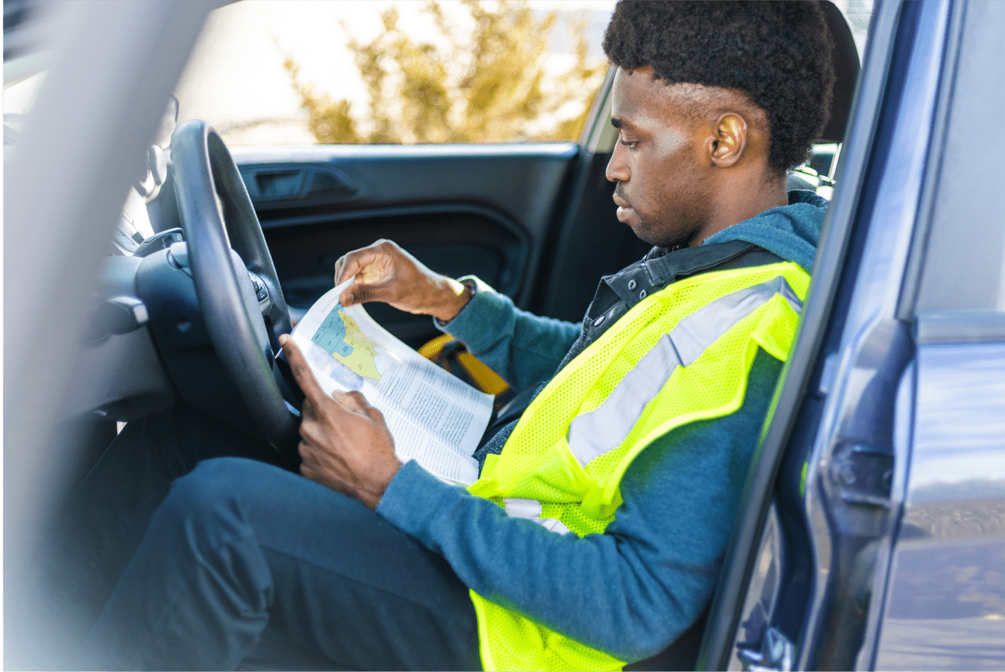 man reading book in truck