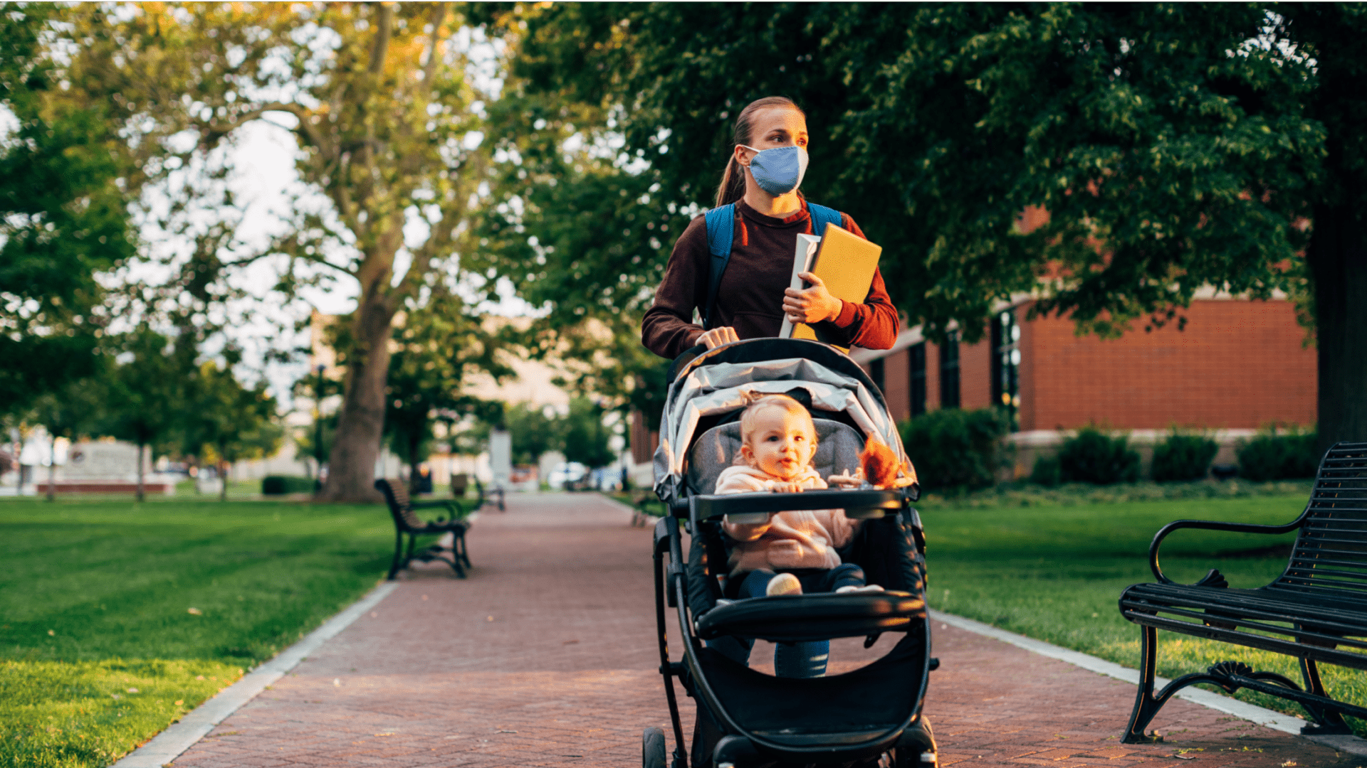 woman walking child in stroller