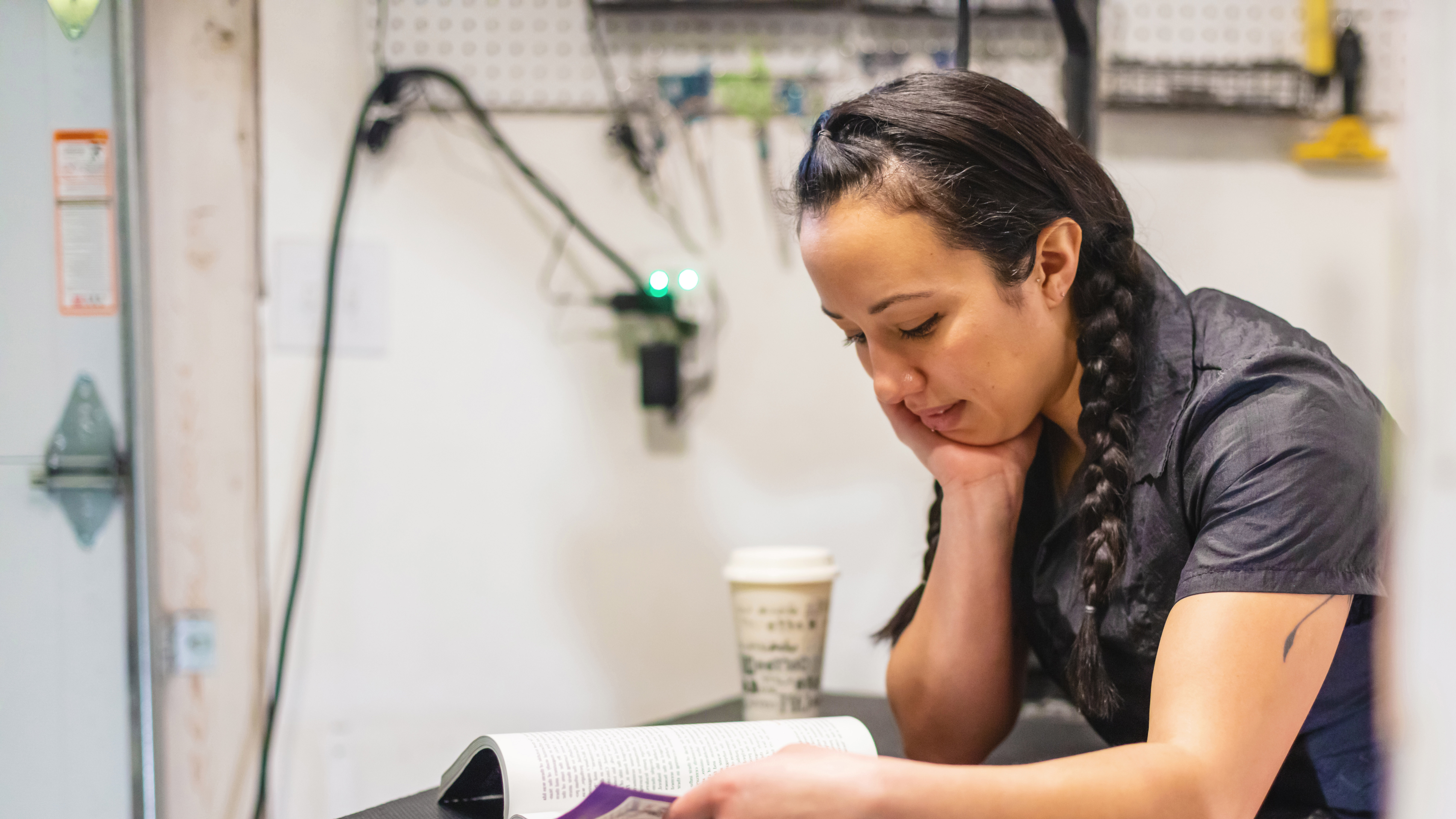 A young woman studies while at work.