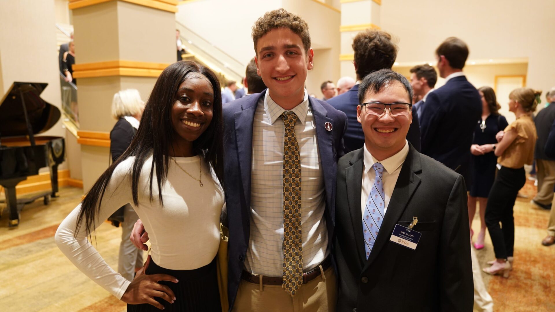 Three smiling students.