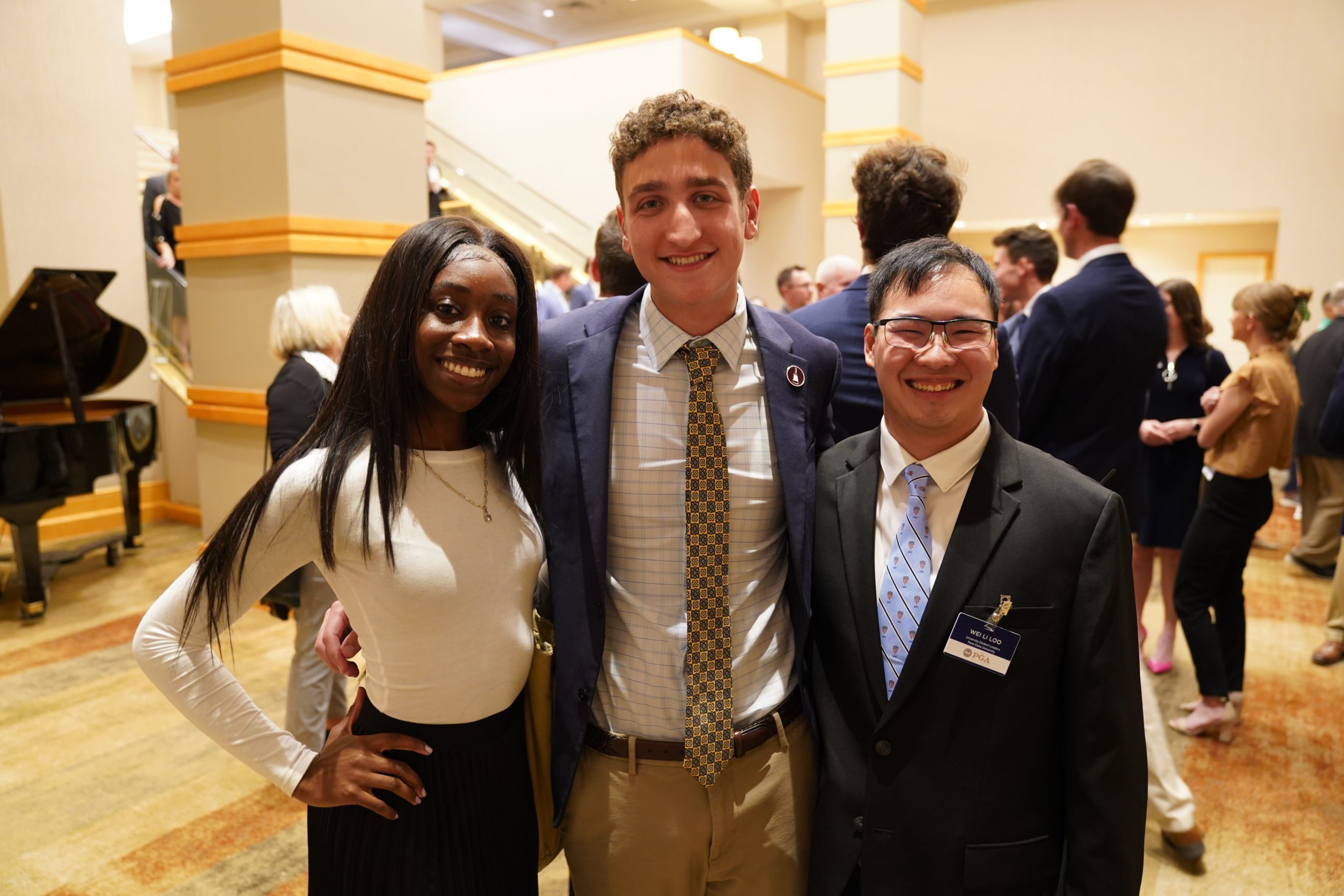 Three smiling students.