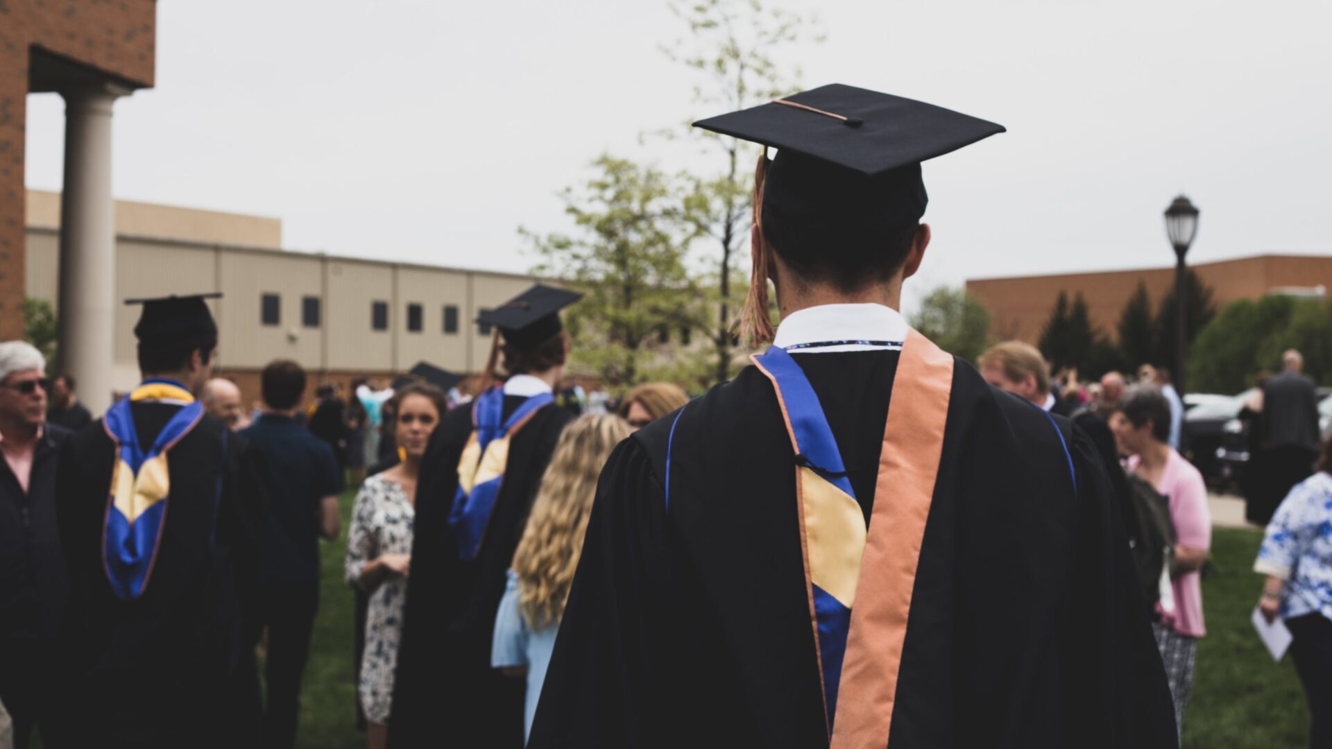 Students on the quad wearing caps and gowns.