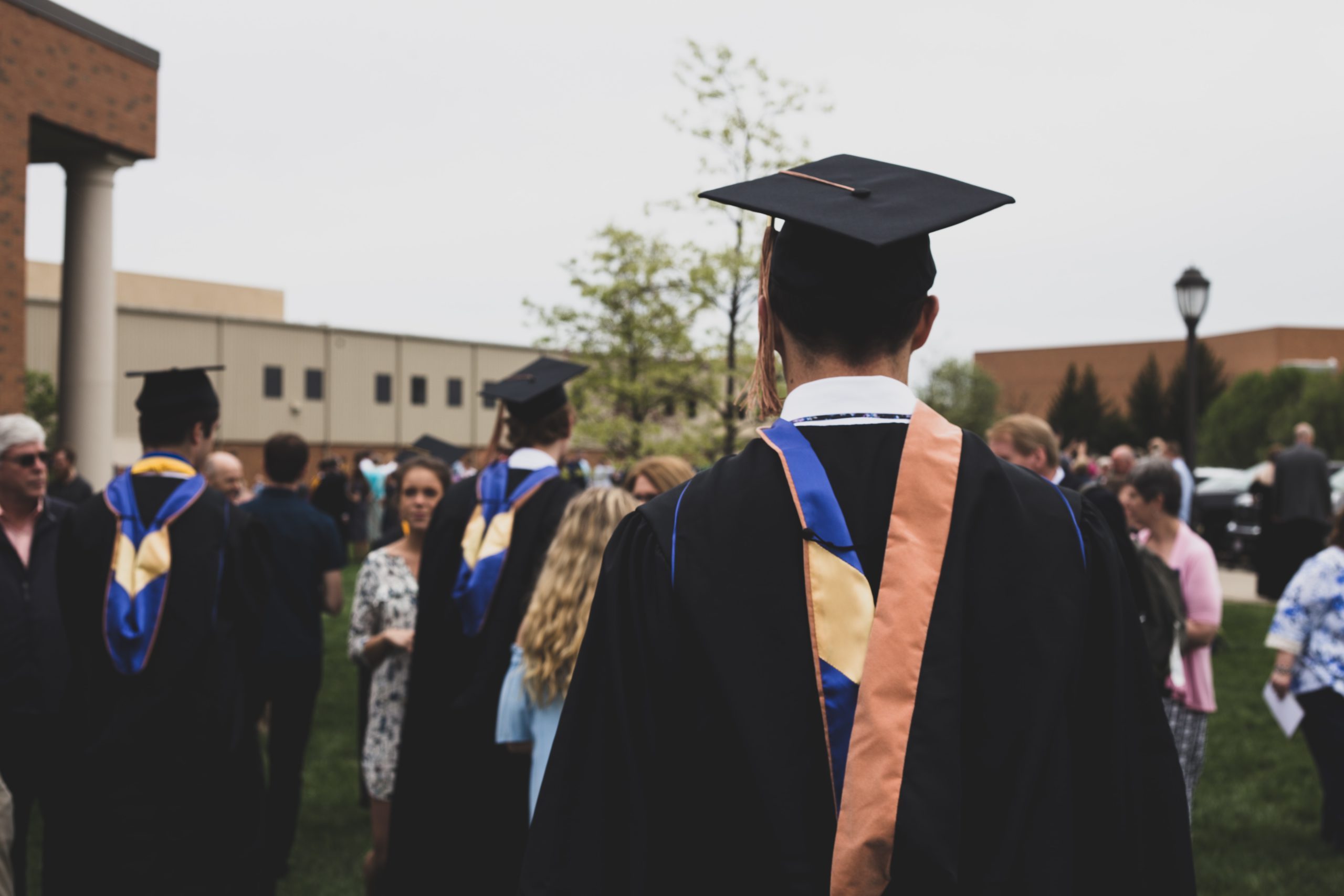 Students on the quad wearing caps and gowns.