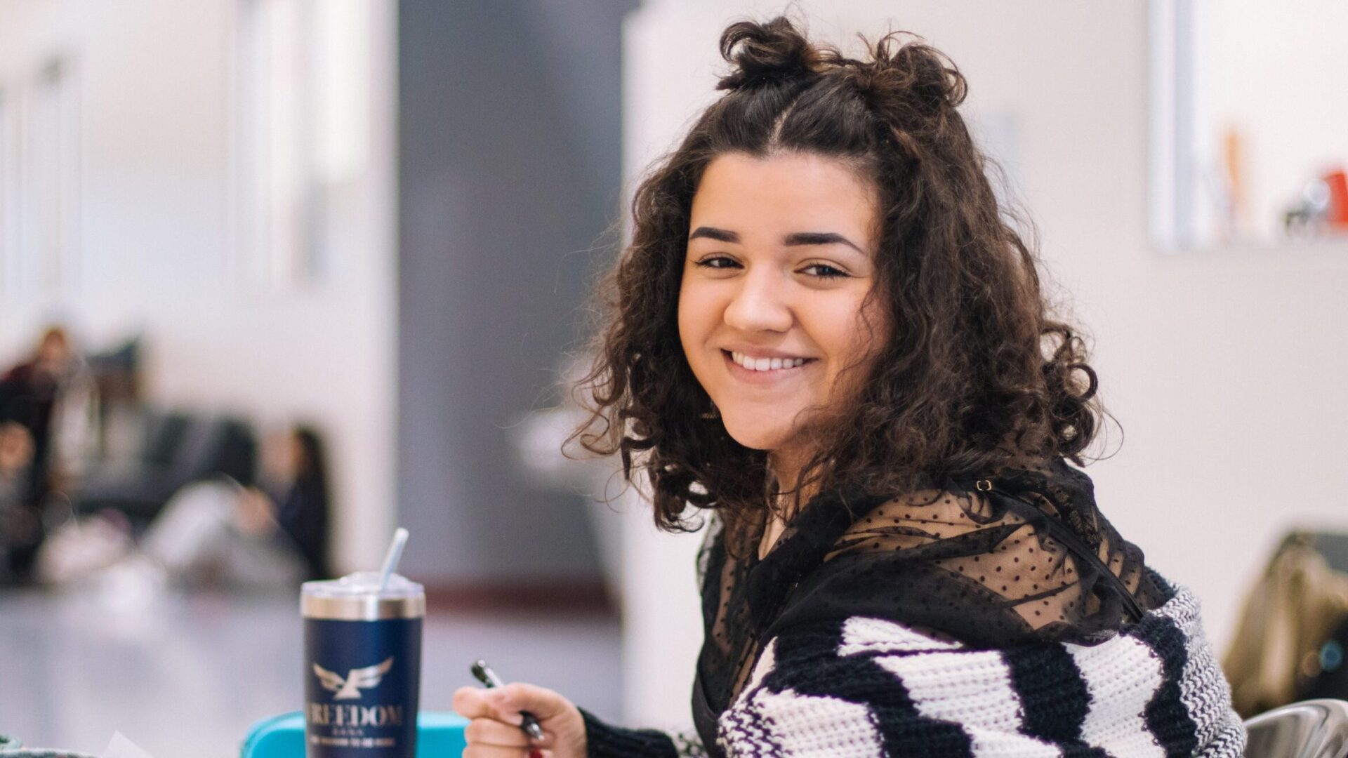 A happy student smiling at the camera.