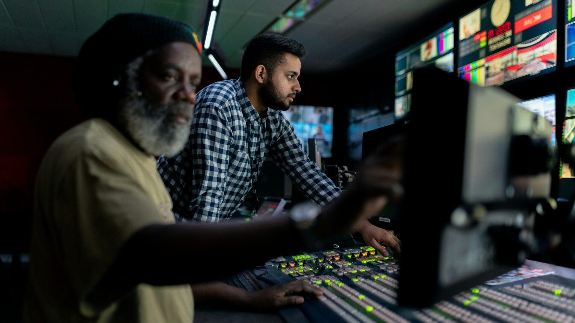 Student and Professor in a technical audio studio looking at a screen off-camera