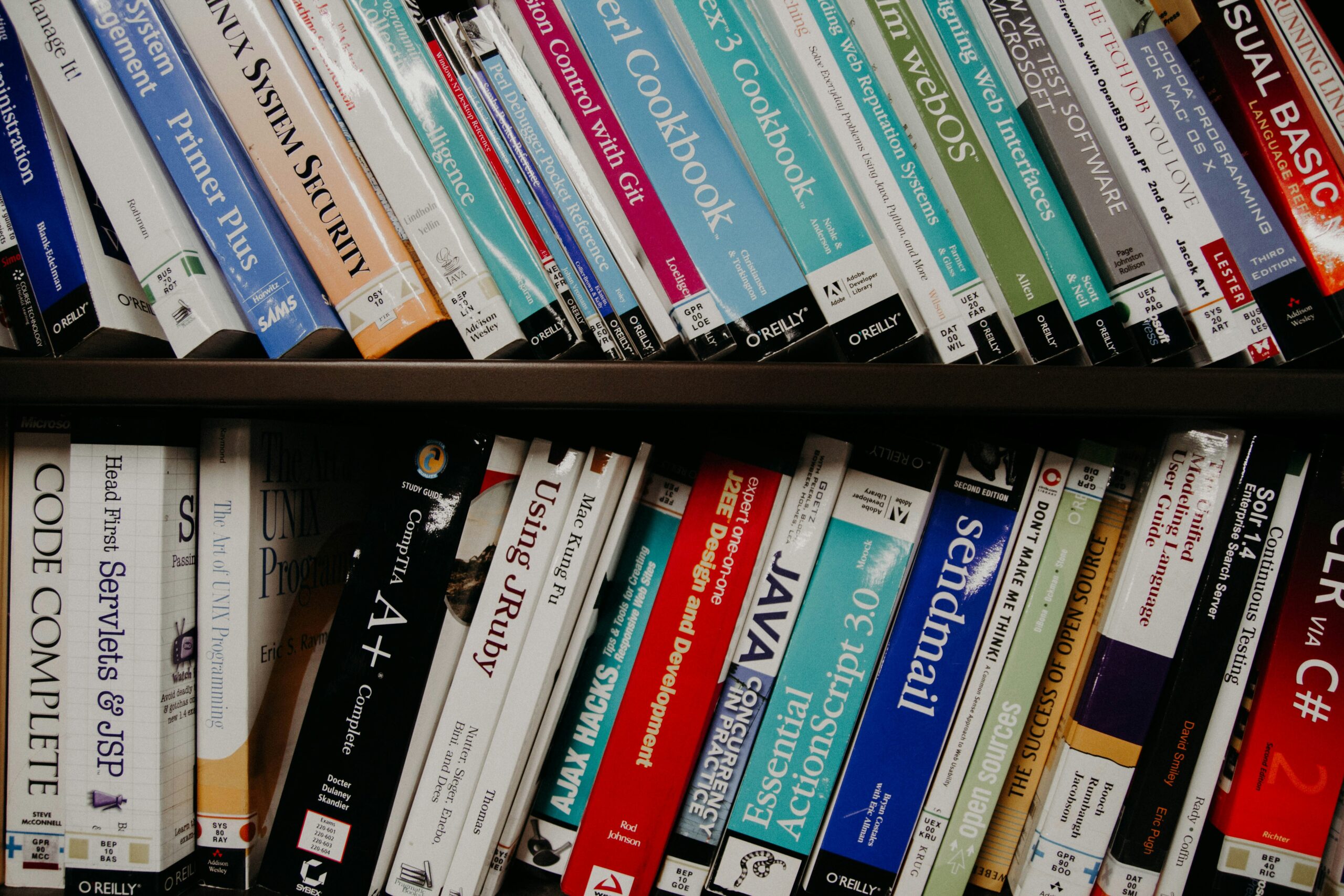 A bookshelf full of technical textbooks.