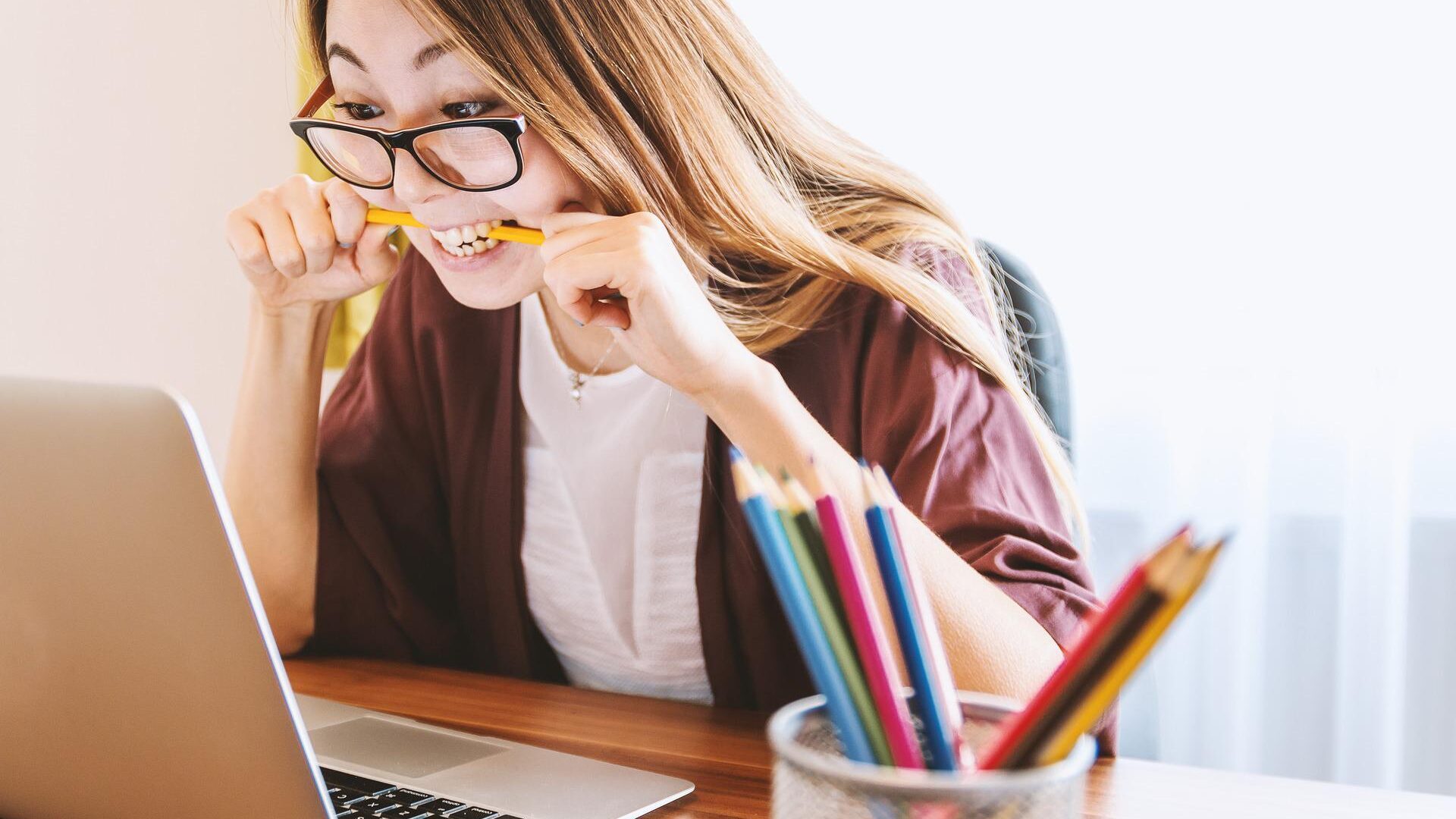 A nervous student bites on her pencil.