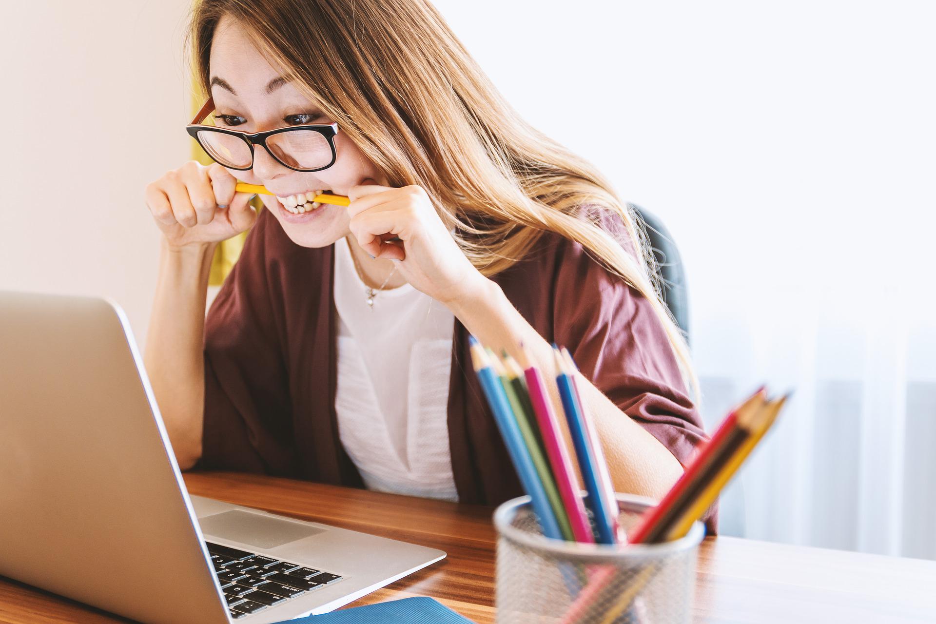 A nervous student bites on her pencil.