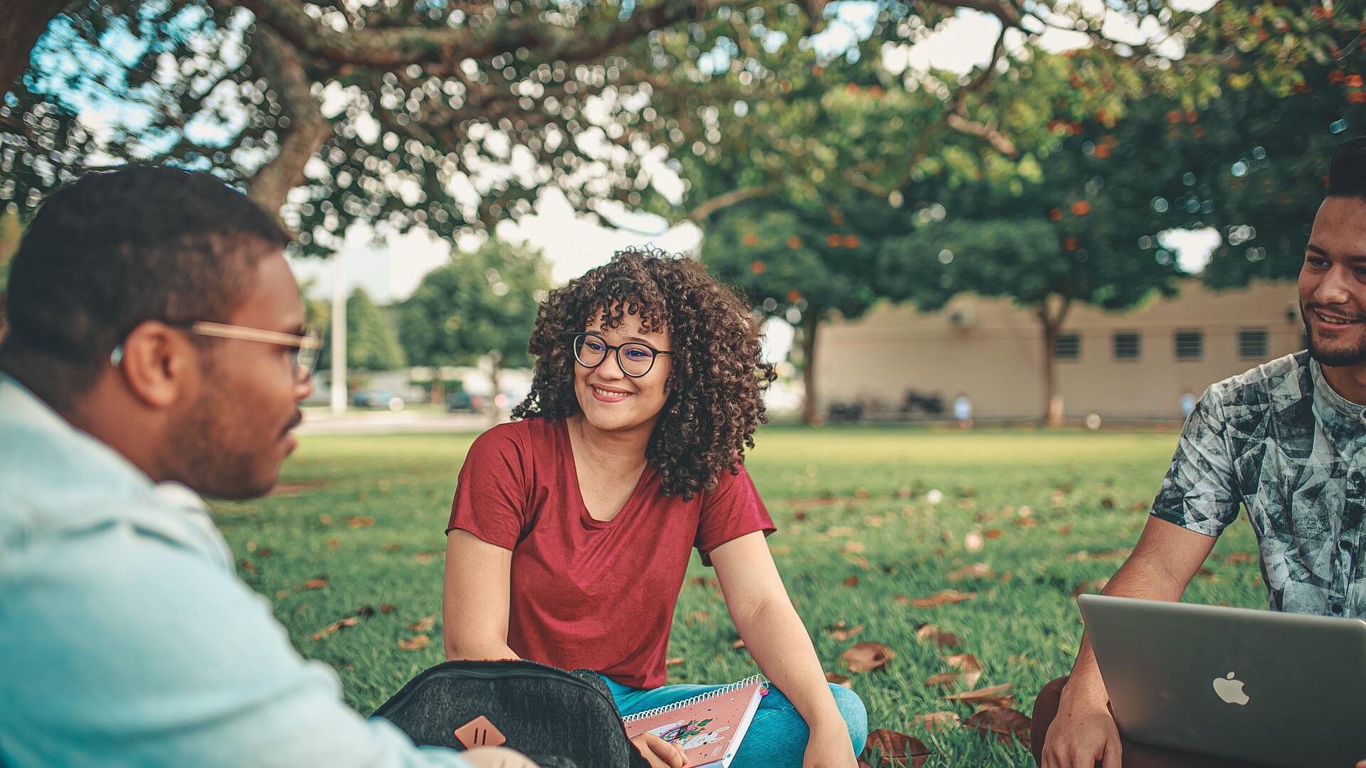 Students sitting in a field.