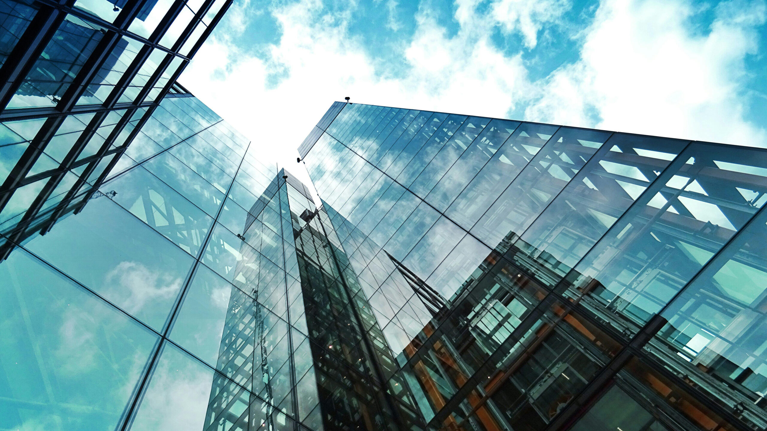 A view of a glass skyscraper from its base.