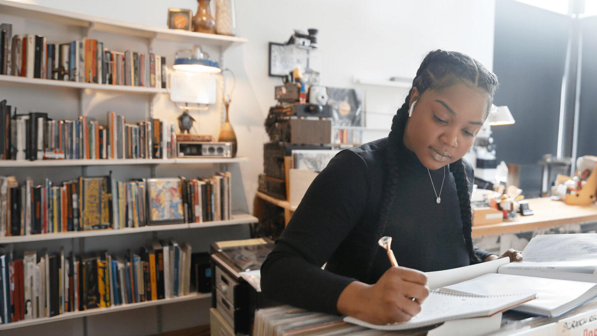 A young student works on schoolwork in a record shop.