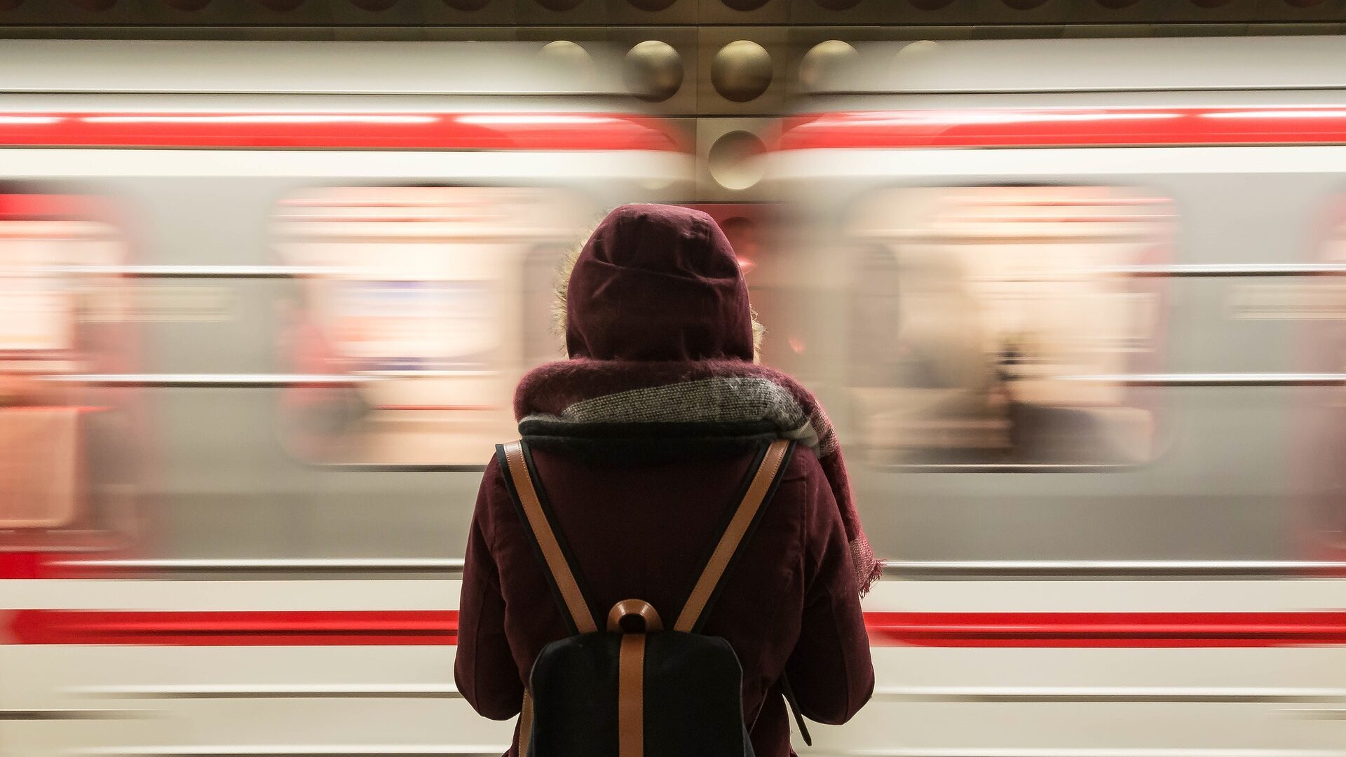 A student waiting for a subway train.