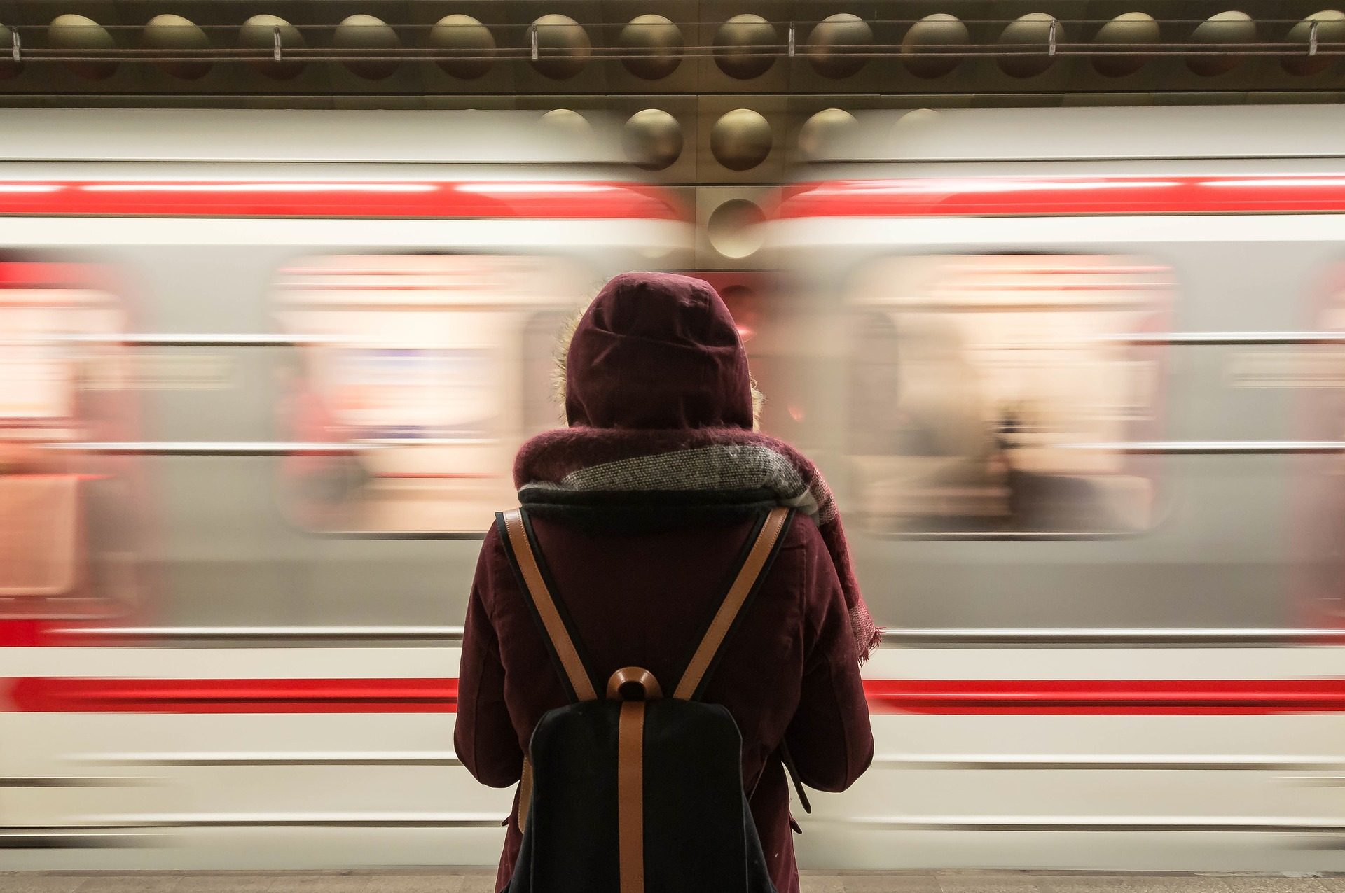 A student waiting for a subway train.