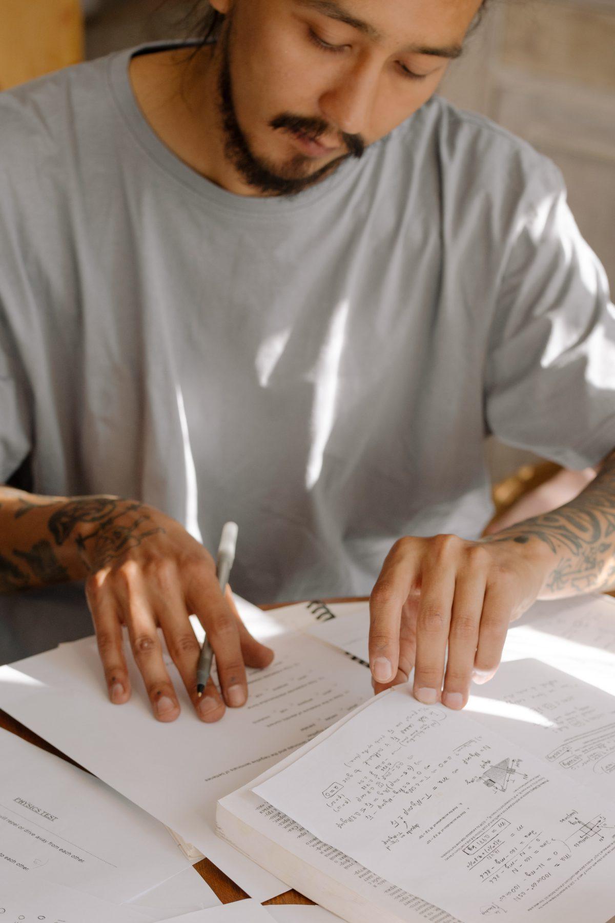 male student studying reading a book.