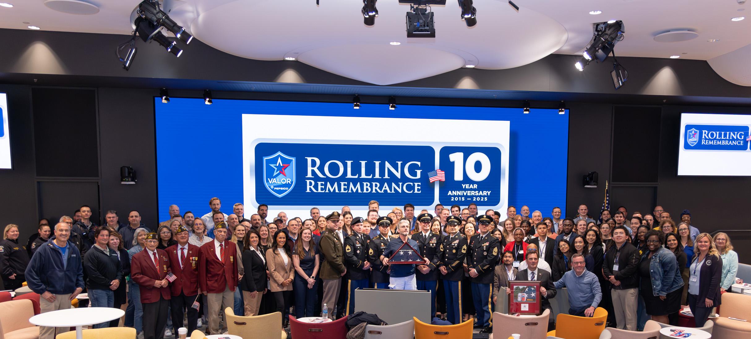 a large group of people in front of a banner celebrating 10 years of Rolling Remembrance