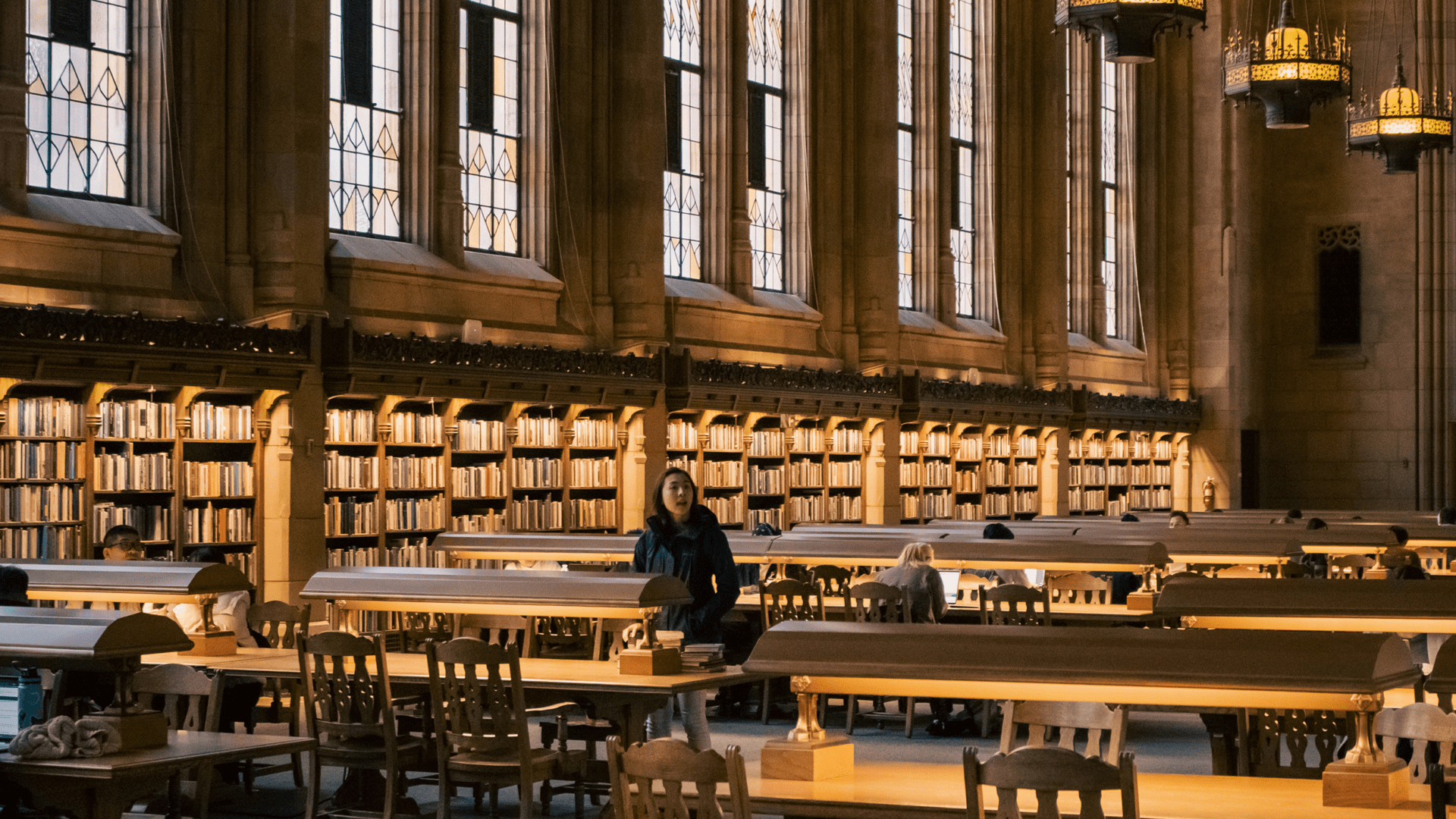 Asian American woman at a table at the Suzzallo Library, University of Washington, Seattle, Washington, USA