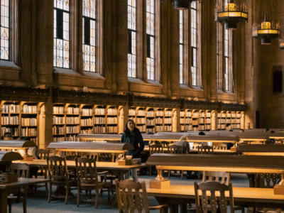 Asian American woman at a table at the Suzzallo Library, University of Washington, Seattle, Washington, USA