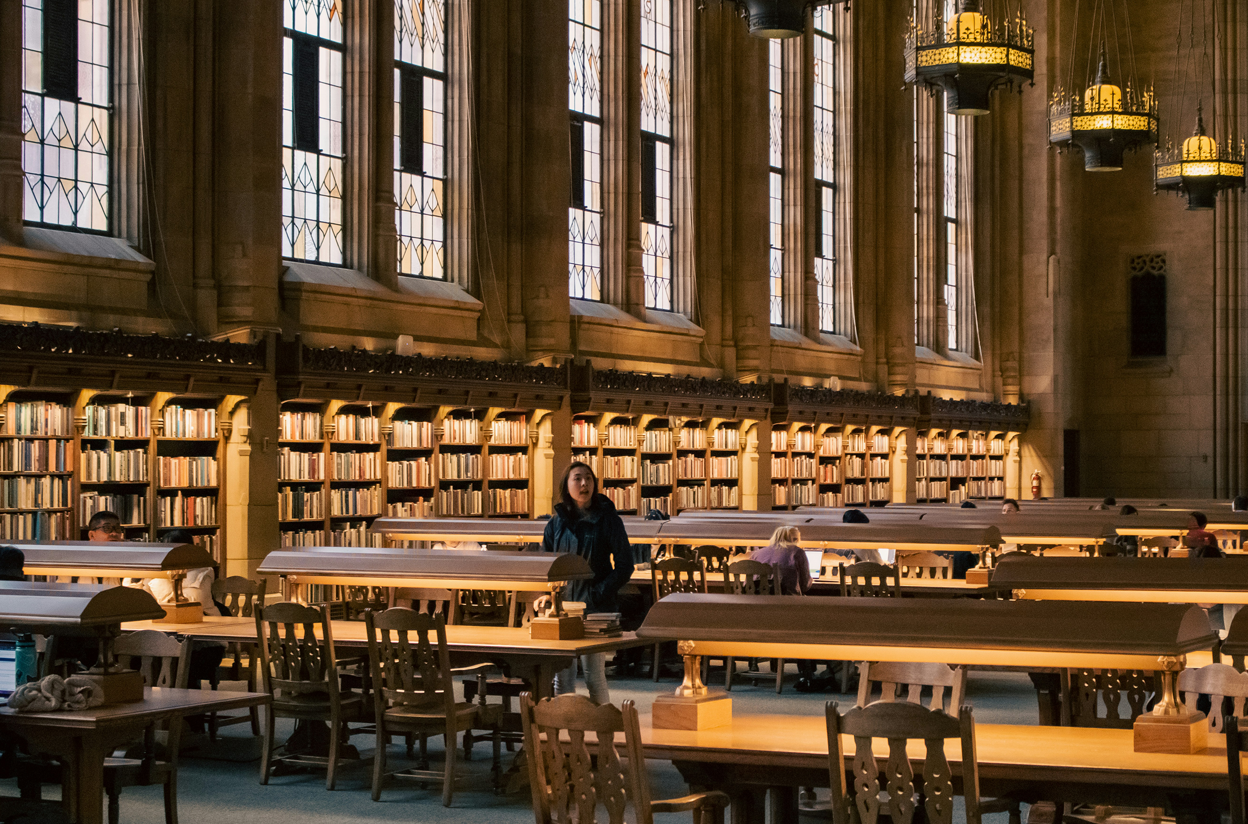 Asian American woman at a table at the Suzzallo Library, University of Washington, Seattle, Washington, USA
